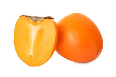 Whole and cut delicious ripe juicy persimmons on white background