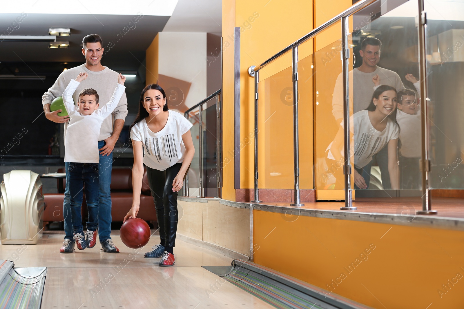 Photo of Happy family spending time together in bowling club