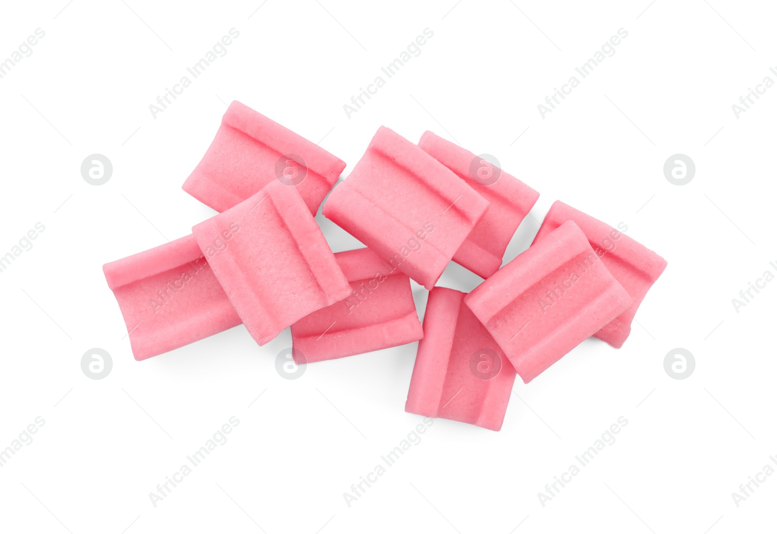 Photo of Many tasty pink chewing gums on white background, top view