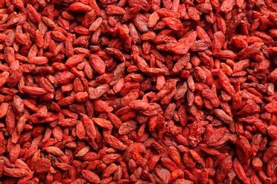 Many dried goji berries as background, top view. Healthy superfood
