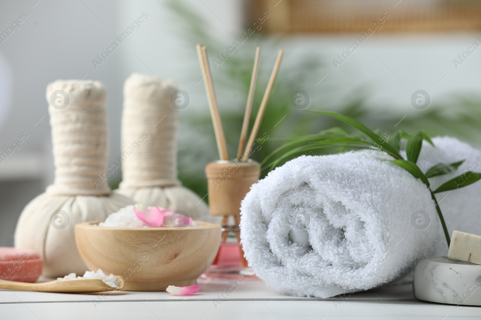 Photo of Beautiful composition with different spa products on white table against blurred background, closeup