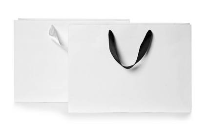 Photo of Paper shopping bags isolated on white. Mock up for design