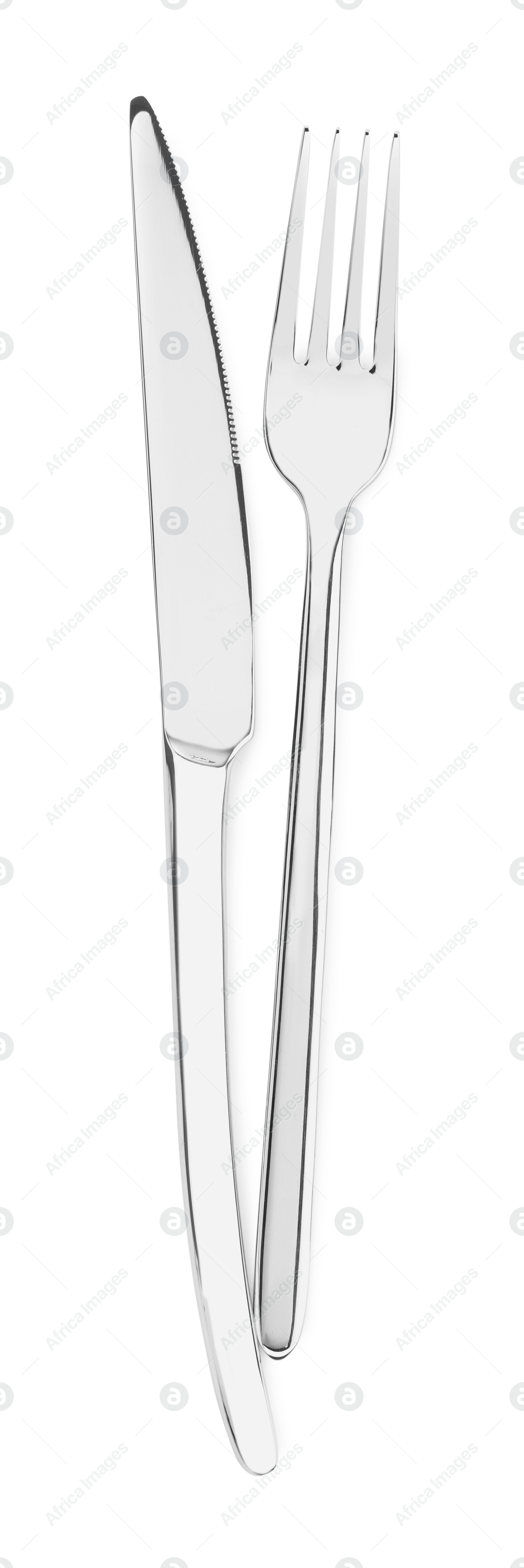 Photo of Fork and knife isolated on white, top view. Stylish shiny cutlery set