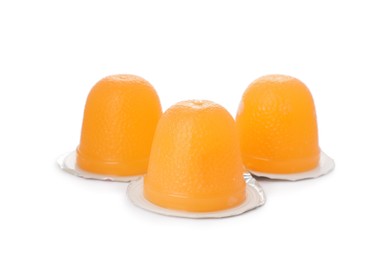 Delicious orange jelly cups on white background