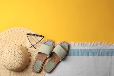 Photo of Flat lay composition with beach accessories on yellow background, space for text