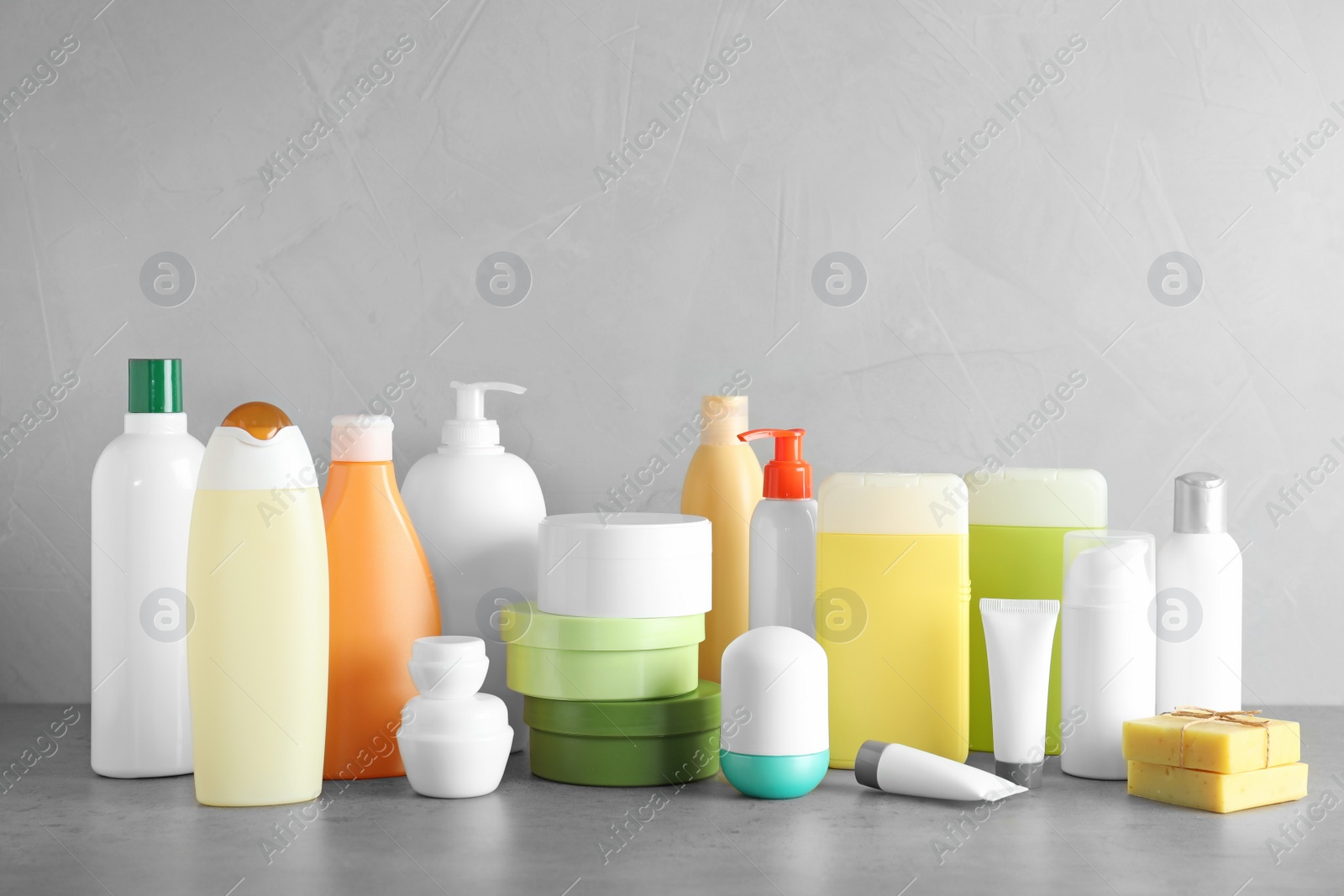 Photo of Different body care products on table against grey background