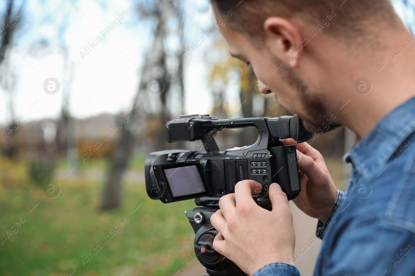 Photo of Video operator with camera working in park