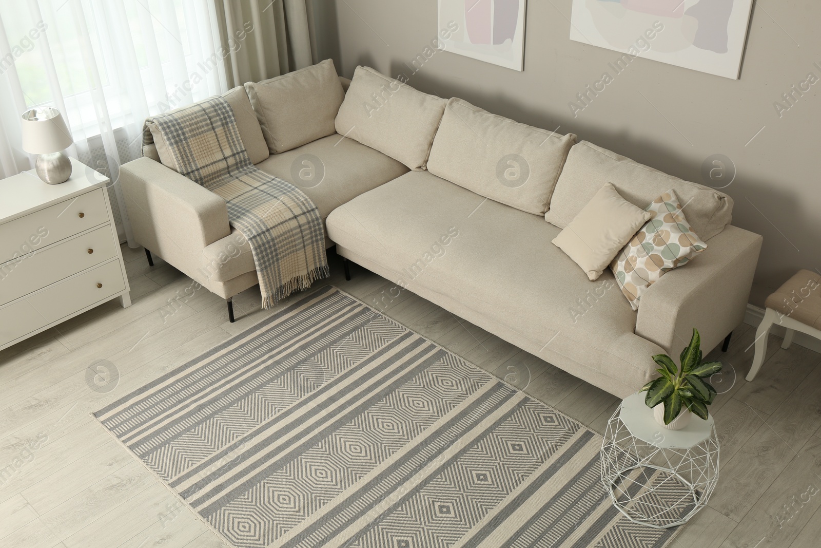 Photo of Living room interior with stylish rug and furniture, above view