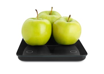 Photo of Electronic scales with ripe green apples on white background