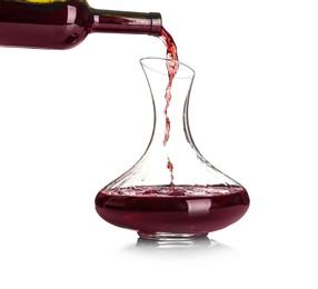 Pouring red wine into elegant decanter on white background