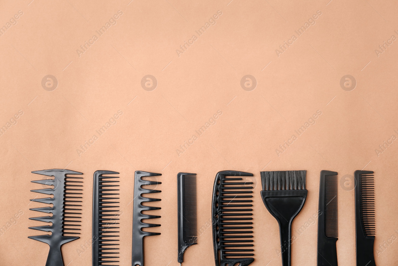 Photo of Flat lay composition with professional hairdresser tools on color background