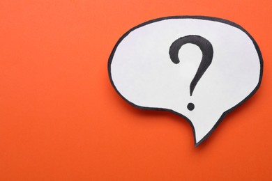 Paper speech bubble with question mark on orange background, top view. Space for text