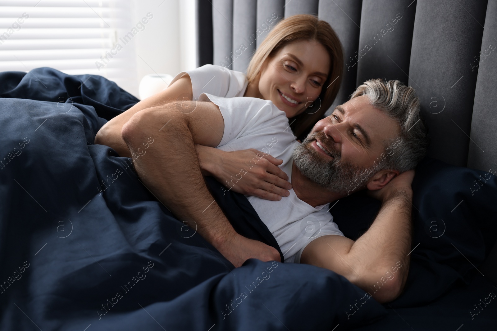 Photo of Lovely mature couple in bed at home