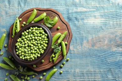 Photo of Flat lay composition with green peas on wooden background