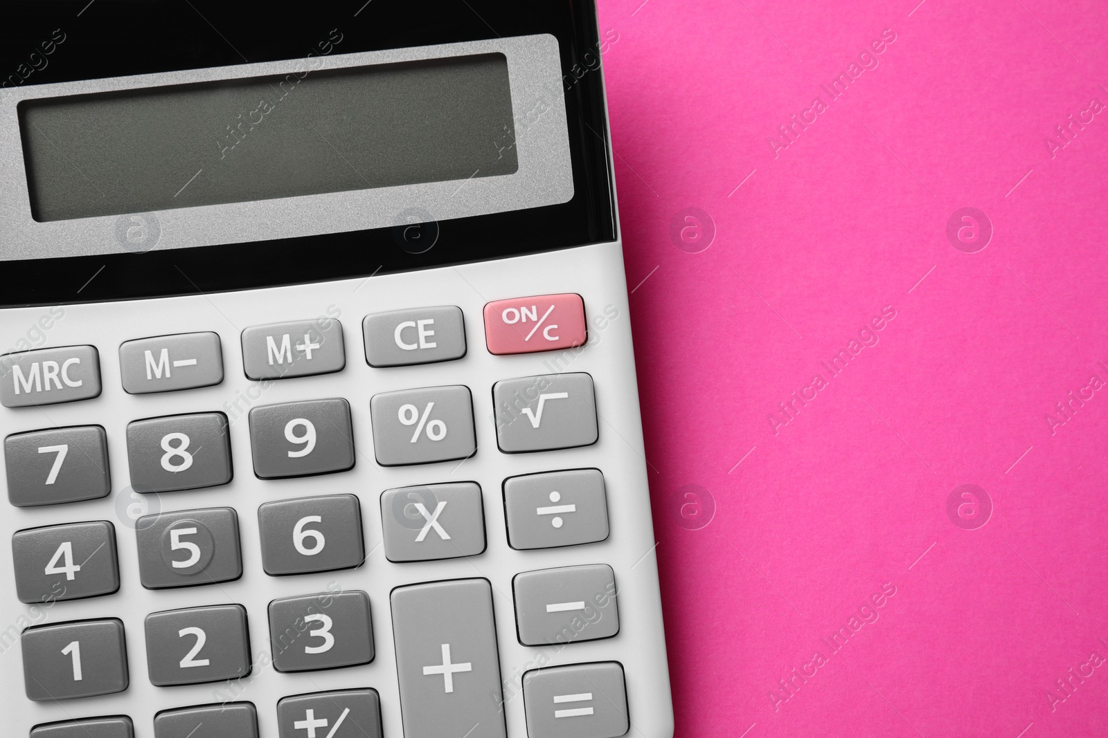 Photo of Calculator on pink background, top view. Space for text