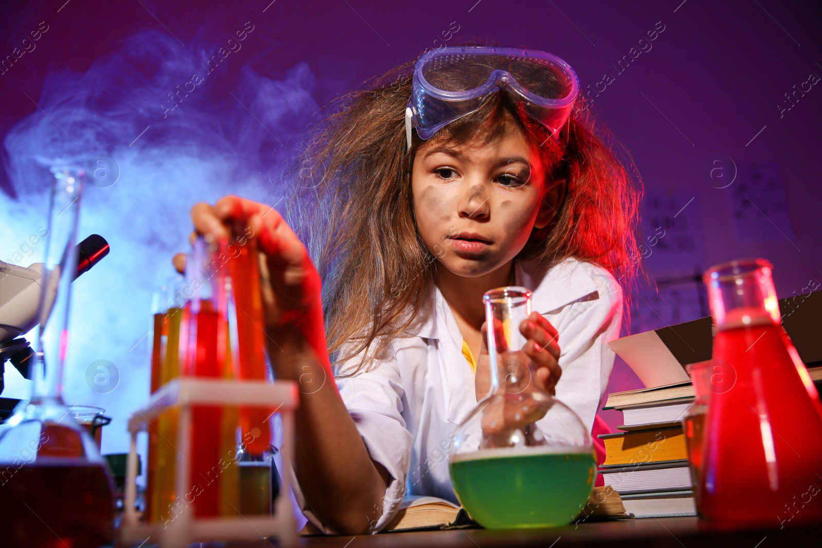 Photo of Child doing chemical research in laboratory. Dangerous experiment