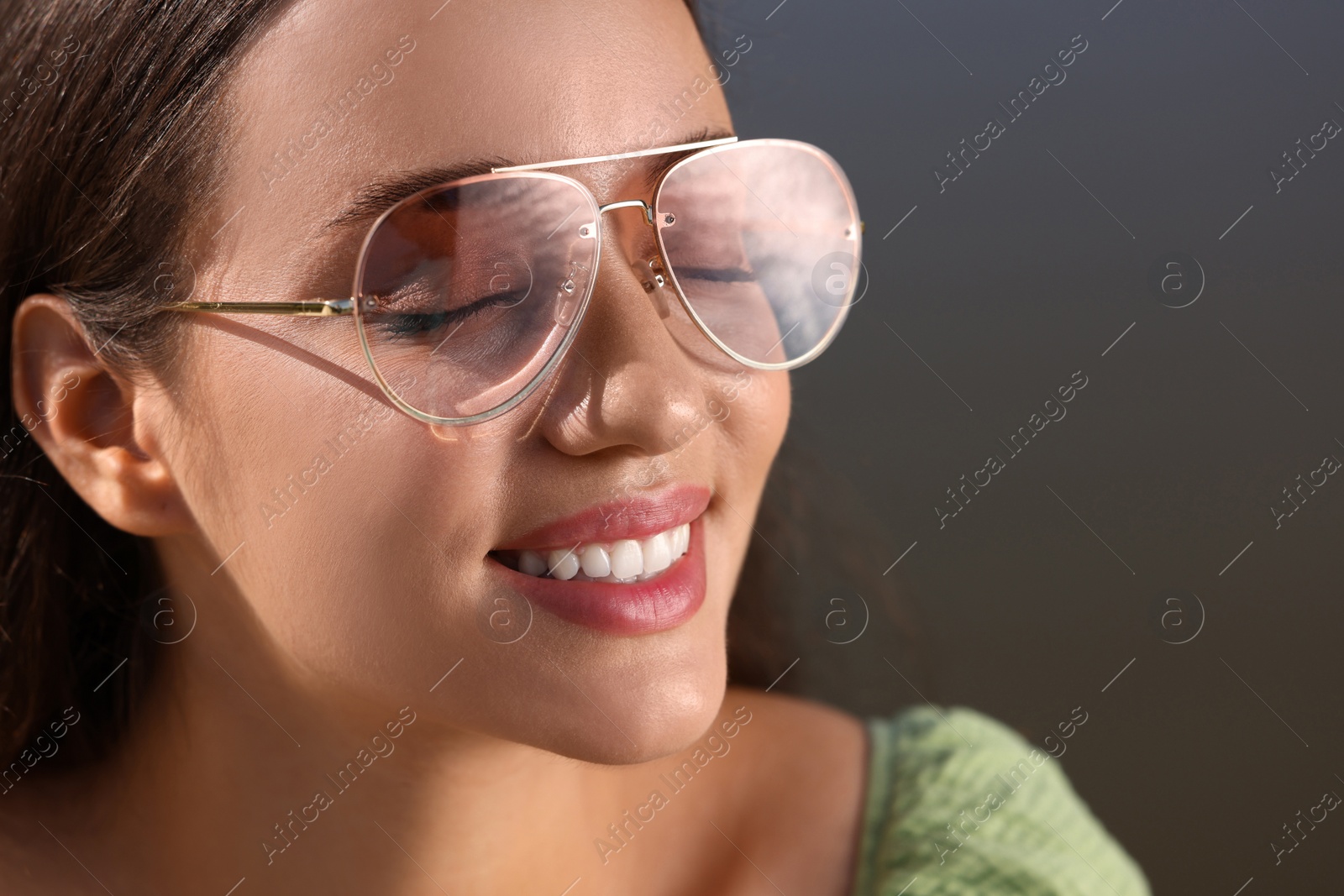 Photo of Beautiful woman in sunglasses outdoors, closeup. Space for text