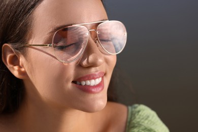 Beautiful woman in sunglasses outdoors, closeup. Space for text