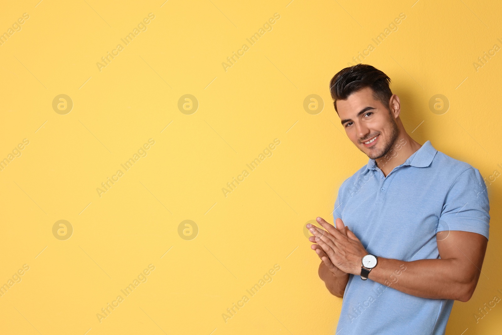 Photo of Portrait of handsome young man and space for text on color background