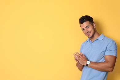 Photo of Portrait of handsome young man and space for text on color background