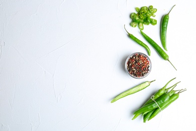 Flat lay composition with chili peppers on white background