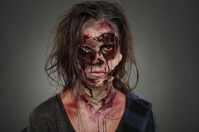 Photo of Scary zombie on dark background. Halloween monster