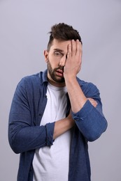 Photo of Man suffering from headache on grey background. Cold symptoms