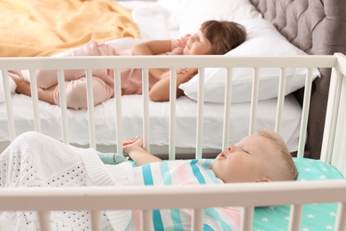 Photo of Little children sleeping in bedroom at home