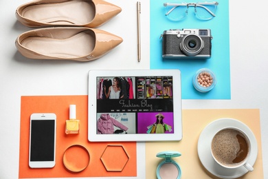 Flat lay composition with tablet and fashion blogger's stuff on color background