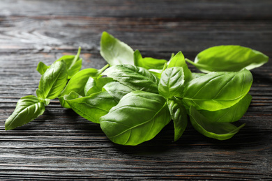 Fresh green basil on black wooden table, closeup