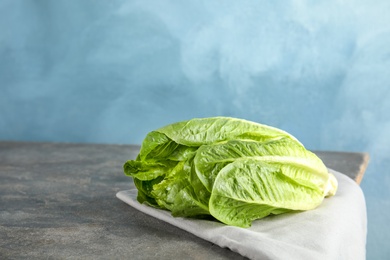 Fresh ripe cos lettuce on table