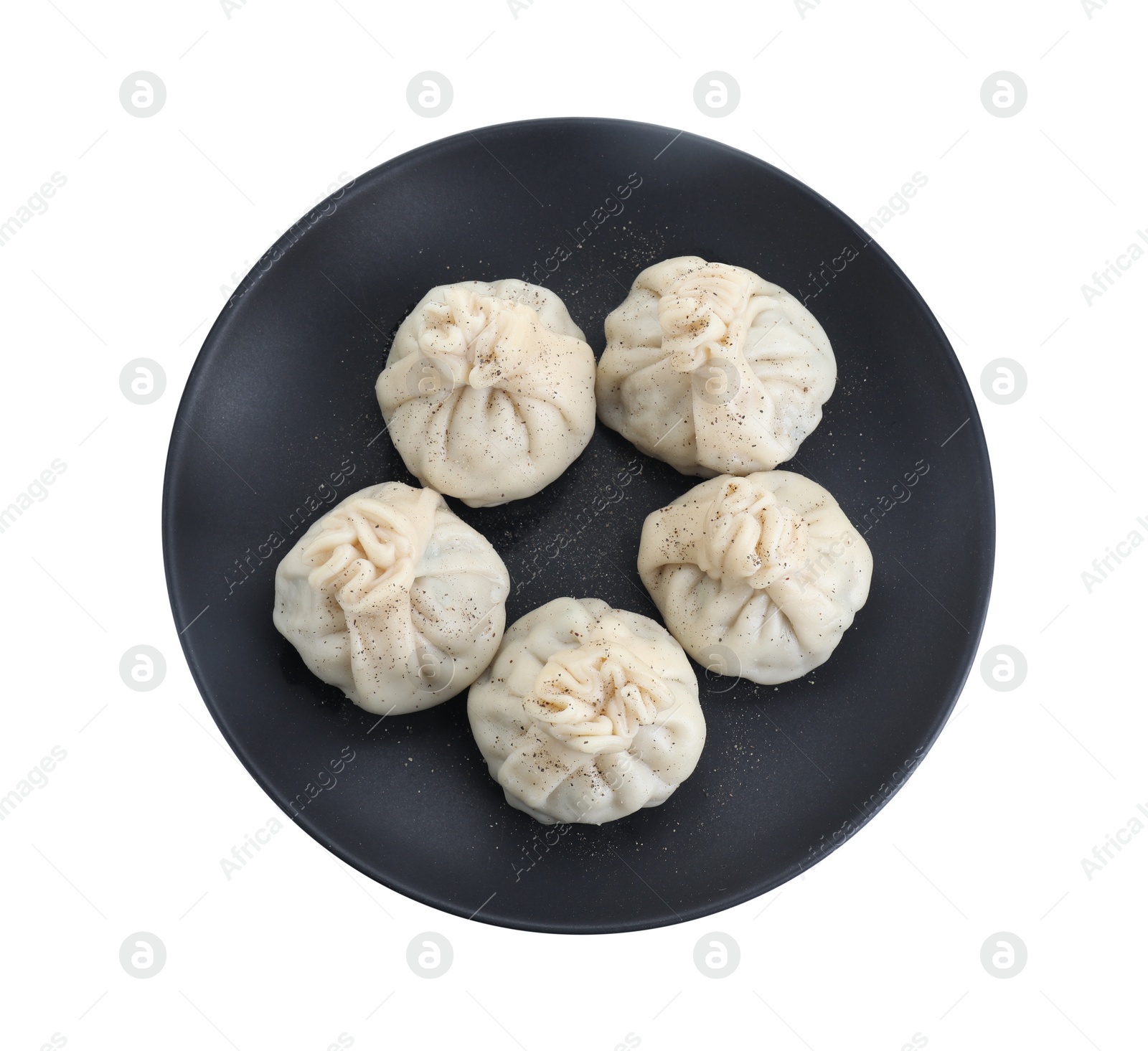 Photo of Plate with tasty fresh khinkali (dumplings) and spices isolated on white, top view. Georgian cuisine