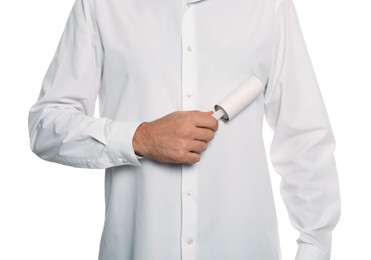 Photo of Man cleaning shirt with adhesive lint roller on white background, closeup