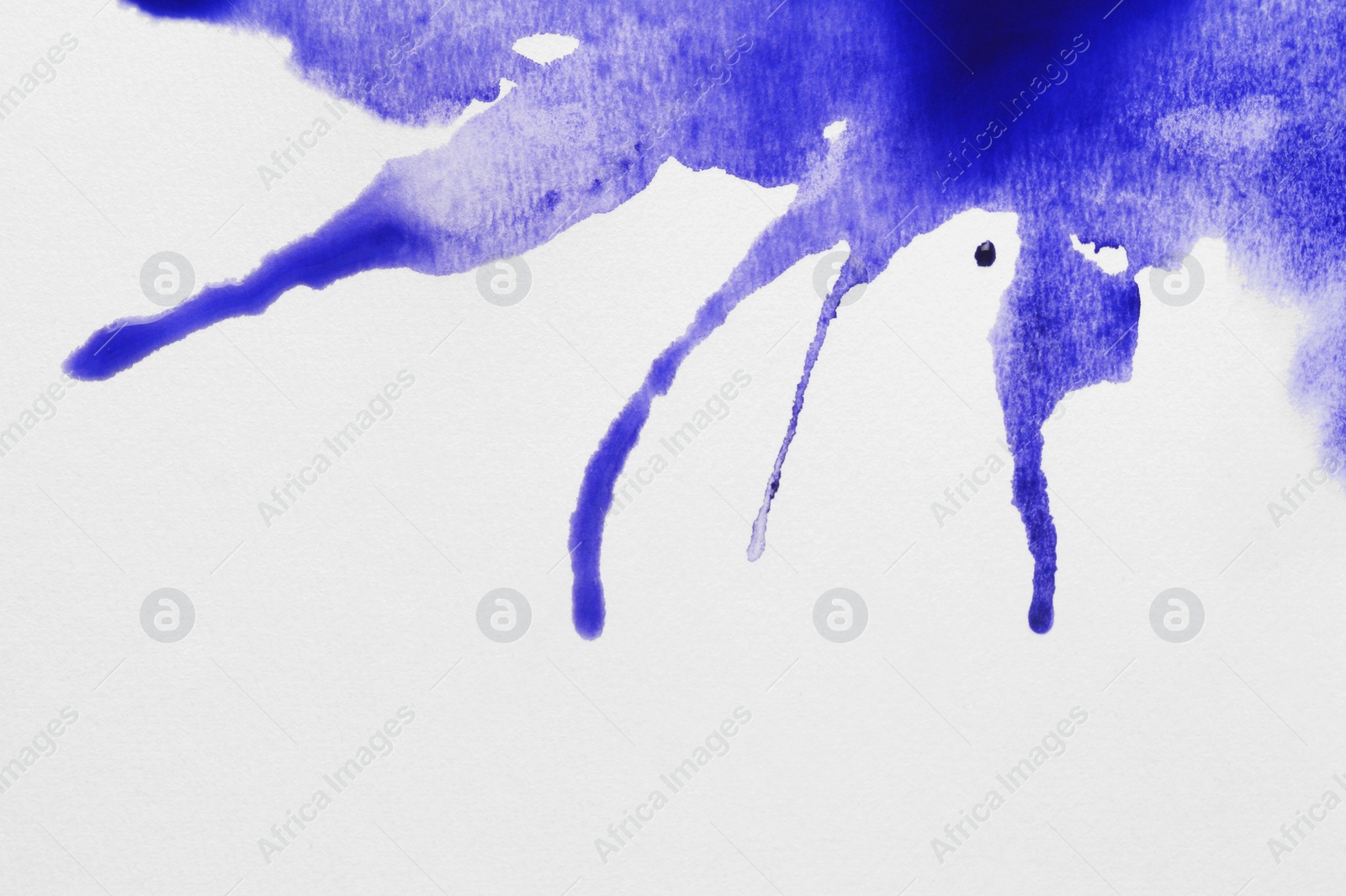 Photo of Blue ink blots on white canvas, top view