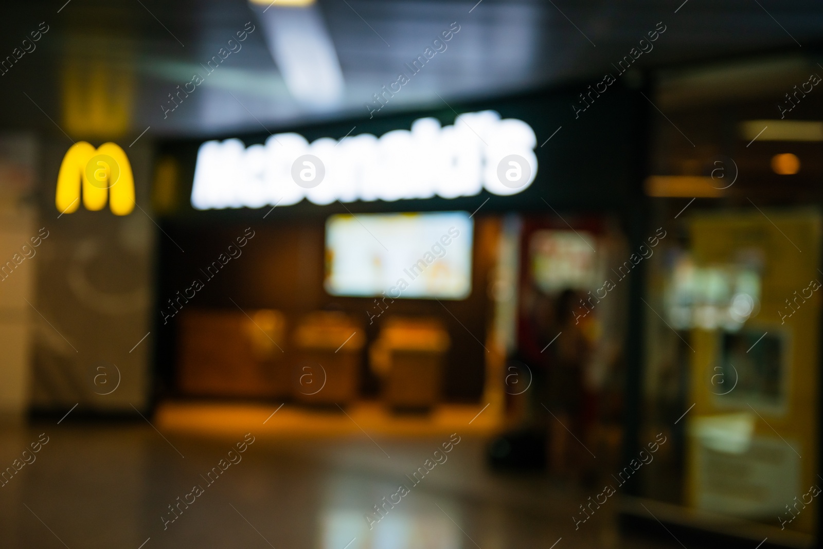 Photo of WARSAW, POLAND - AUGUST 05, 2022: Blurred view of McDonald's Restaurant entrance indoors