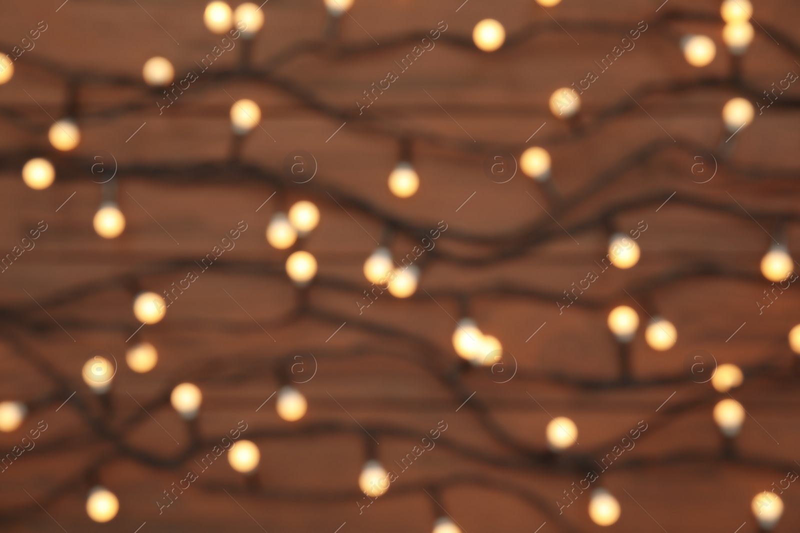 Photo of Blurred view of glowing Christmas lights as background