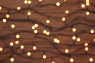 Photo of Blurred view of glowing Christmas lights as background