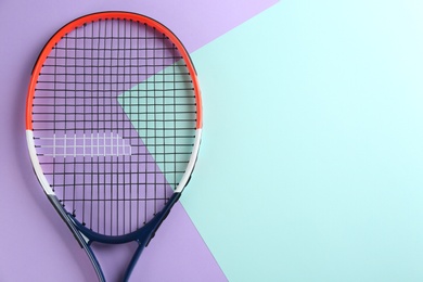 Photo of Tennis racket on color background, top view. Space for text