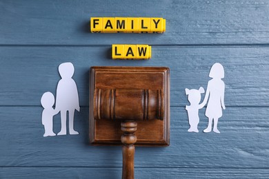 Family law concept. Flat lay composition with judge gavel on blue wooden background