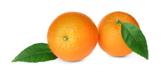 Photo of Fresh ripe oranges with green leaves on white background