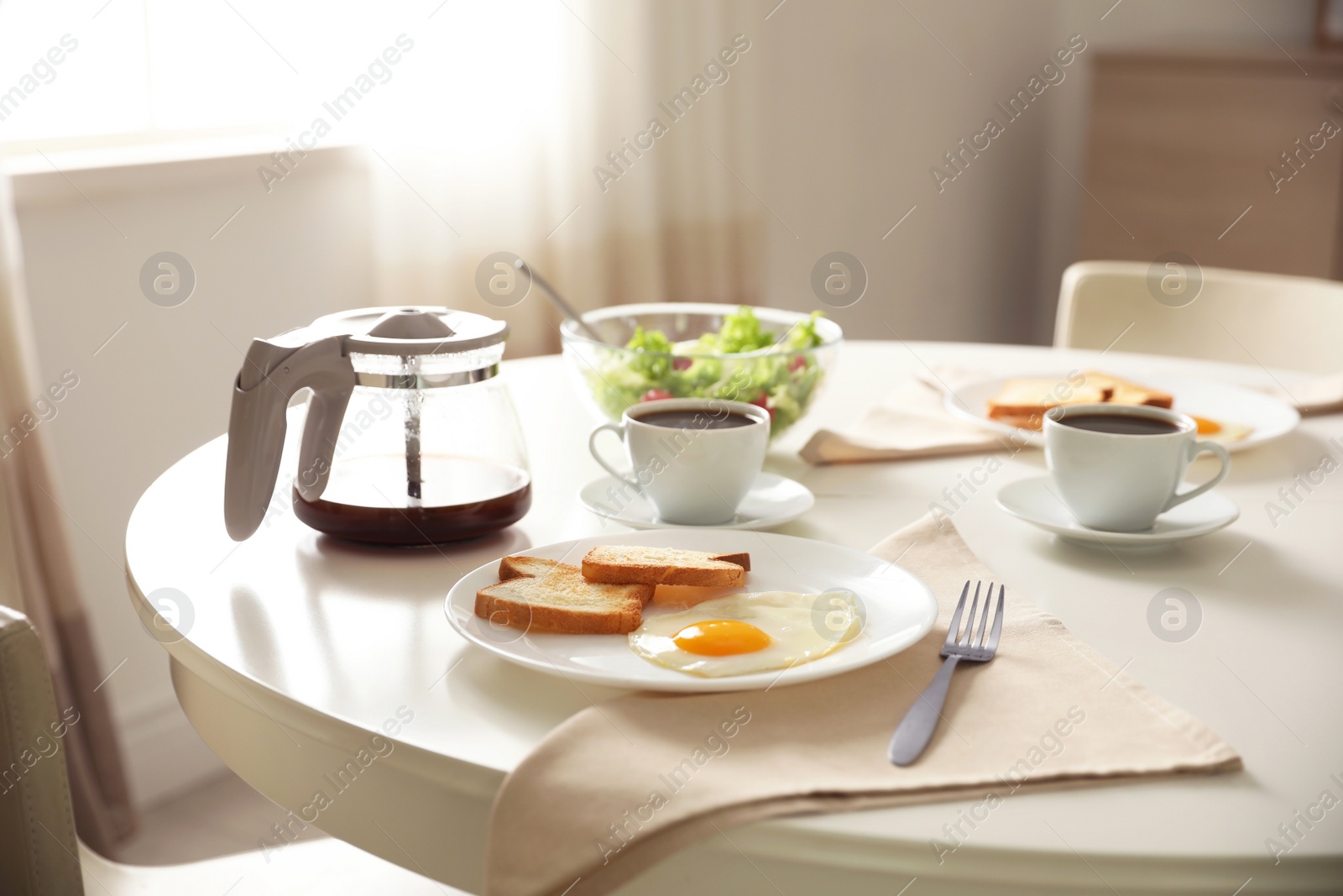 Photo of Tasty breakfast served on table in light room