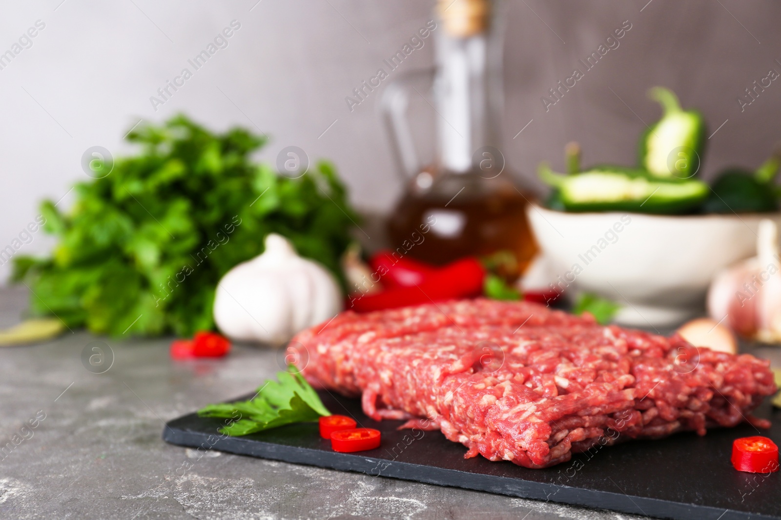 Photo of Fresh raw minced meat on grey table