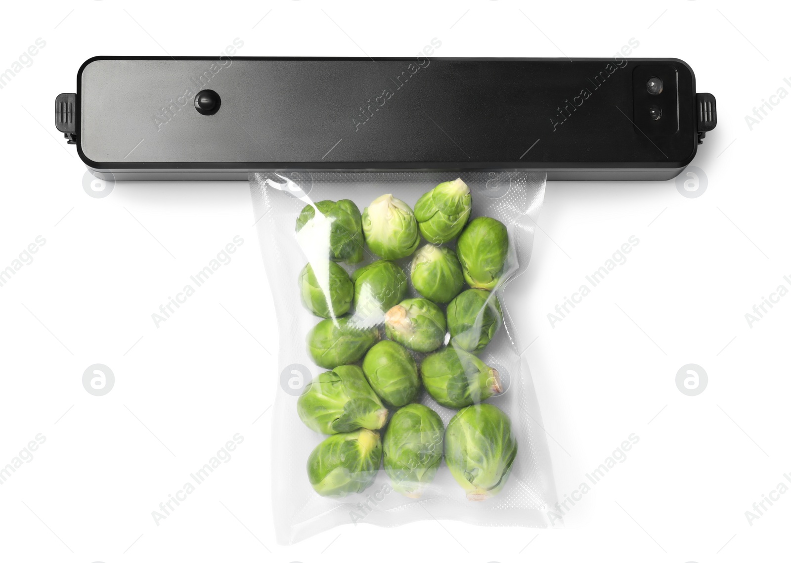 Photo of Sealer for vacuum packing and plastic bag with Brussels sprouts on white background, top view