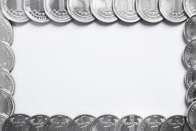 Photo of Frame of Ukrainian coins on white background, top view. National currency