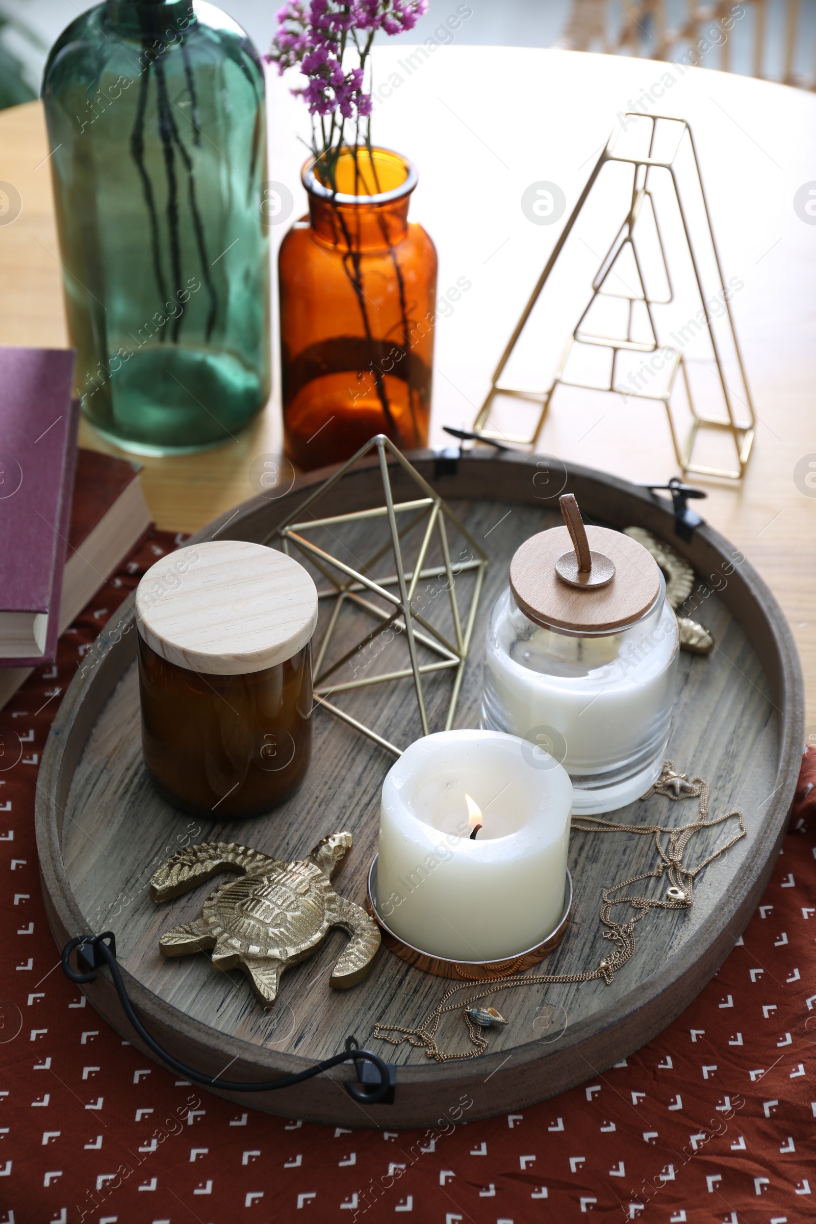 Photo of Wooden tray with decorations and candles on table