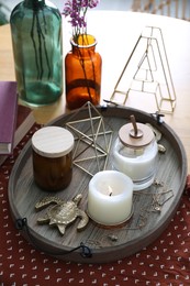 Photo of Wooden tray with decorations and candles on table