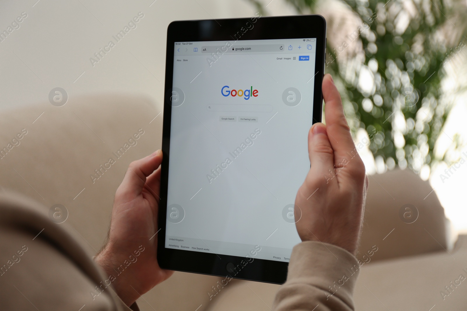 Photo of MYKOLAIV, UKRAINE - OCTOBER 27, 2020: Man using Google search engine on tablet against blurred background, closeup