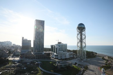 Photo of Batumi, Georgia - October 12, 2022: Alphabetic Tower and modern buildings in city near sea