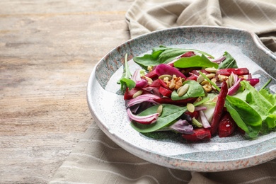 Plate with delicious beet salad served on table