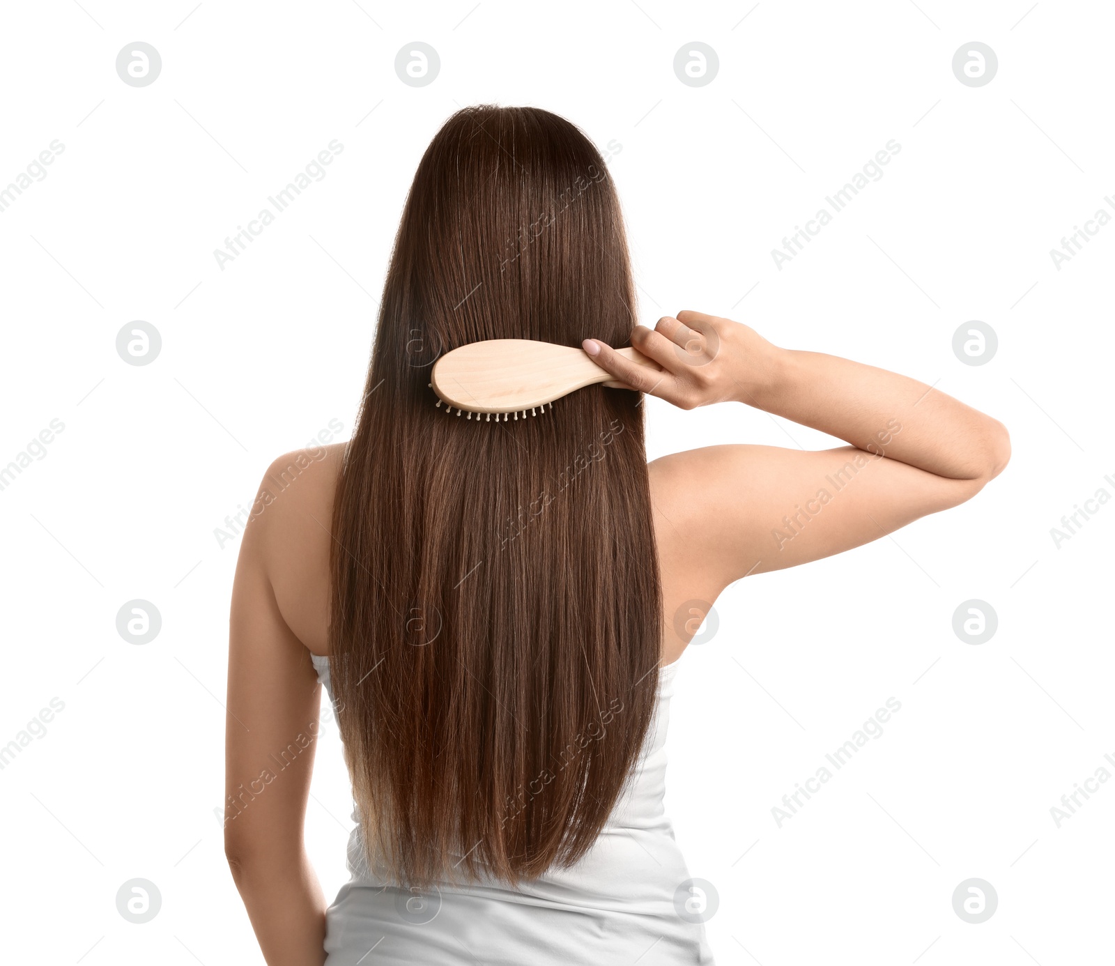 Photo of Back view of young woman with hair brush on white background